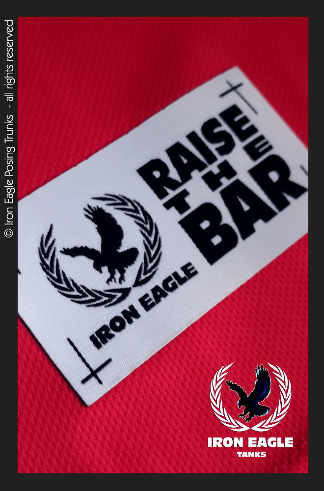Fire red Iron Eagle training tank with black eagle logo and bold “Raise the Bar” graphic; no posing trunks visible. - Iron Eagle Training Tank - Fire Red - S