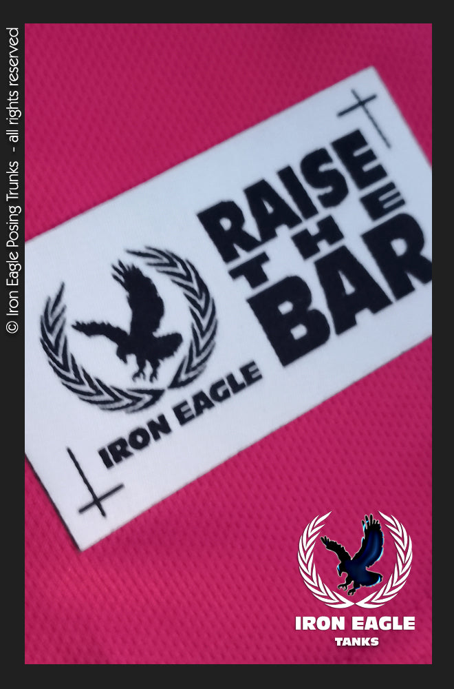 Cerise textured posing trunks with a white Iron Eagle “Raise the Bar” label and black graphics. - Iron Eagle Training Tank - Cerise - S