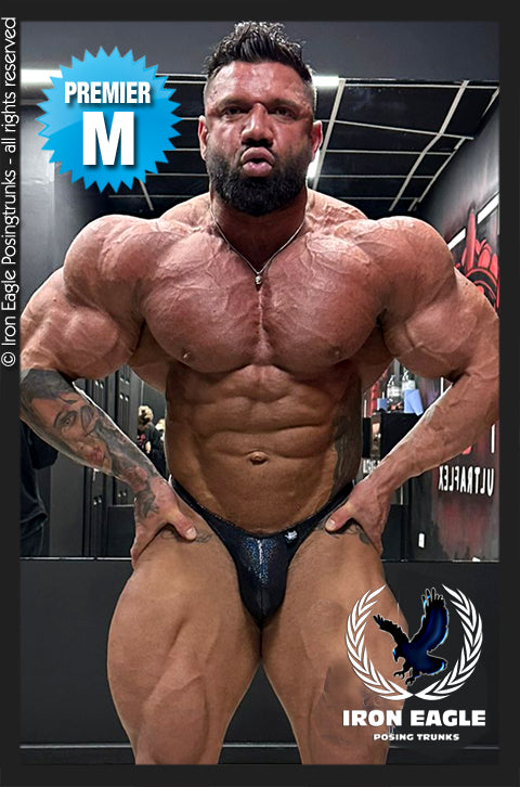 Black holographic posing trunks with a glossy finish, worn by a bodybuilder onstage. - Black Hologram Mystique - Premier / S / With