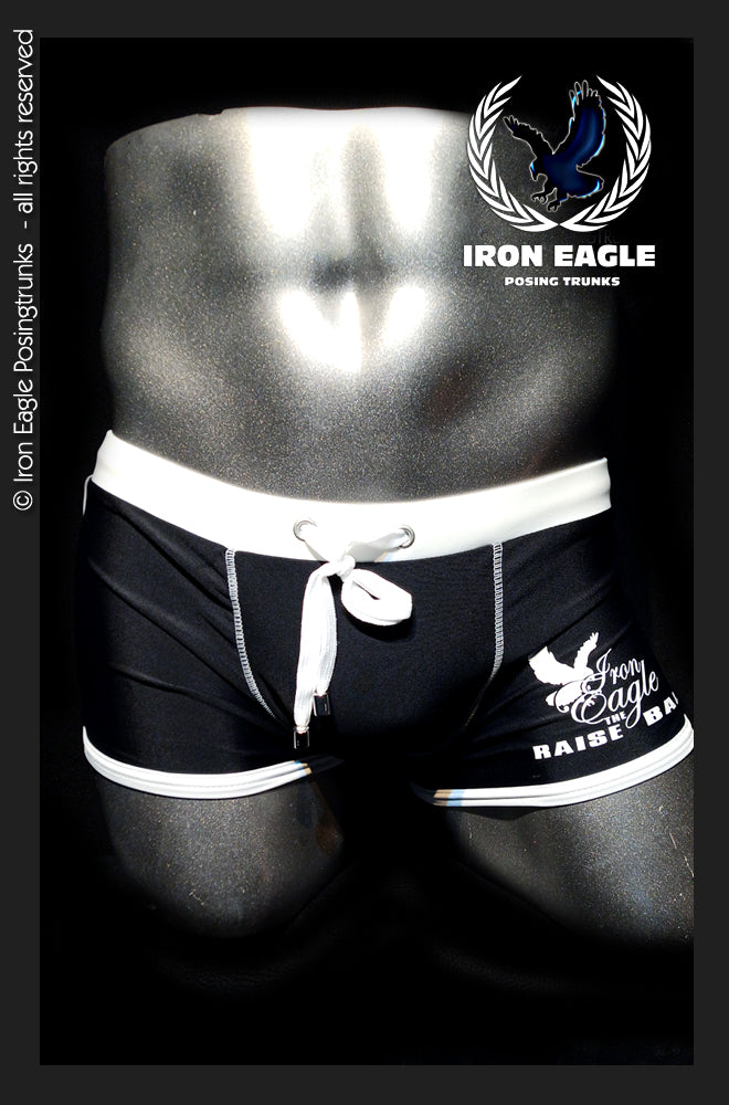Black low-rise posing trunks with white waistband, drawstring, piping, and side logo. - Low Rise Trunks - black/white - M / With