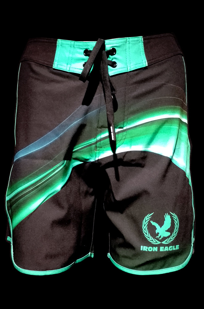 Black posing trunks with bright teal and green wave stripes, drawstring waist, and teal eagle logo. - - Wizard - 15'' LR - 28'' (*actual waistband length 29'')