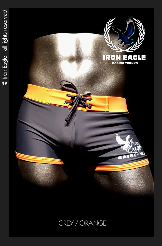 Grey low-rise posing trunks with bright orange trim, front lacing, and white thigh graphics. - Low Rise Trunks - grey/orange - M / With