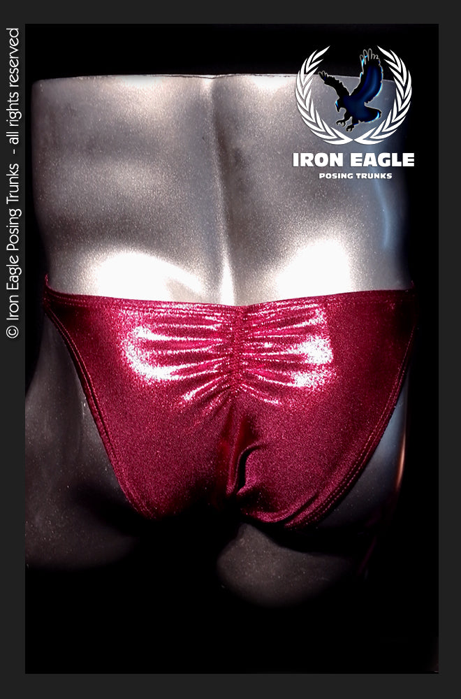 Shimmering ruby-red posing trunks with a ruched front, shown on a bodybuilder. - Ruby Mystique - Premier / S / With